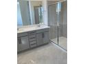 Modern bathroom with dual sink vanity and glass enclosed shower at 2536 Vandra St, Las Vegas, NV 89138