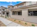 A modern townhome with stone landscaping and a sidewalk leading to the front entrance showcases a contemporary design at 2536 Vandra St, Las Vegas, NV 89138
