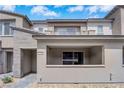 A modern townhome with a covered porch, stone accents, and stylish architecture provides curb appeal at 2536 Vandra St, Las Vegas, NV 89138