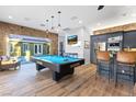 Entertain in this game room with a pool table, wet bar, and seamless indoor-outdoor living with folding doors at 2822 Ashby Ave, Las Vegas, NV 89102