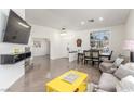 Open-concept living area with tile flooring, dining space, and contemporary decor at 286 Fairmeadow St, Henderson, NV 89012