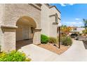 Building exterior featuring an arched doorway and covered entrance for residents at 3150 Soft Breezes Dr # 1037, Las Vegas, NV 89128