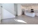 Bright living area with stairs, tile floors, and an open layout to the kitchen with stainless steel appliances at 3210 Centano Ave, Henderson, NV 89044