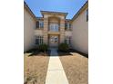 Elegant home entrance featuring a private balcony and manicured shrubs at 357 Whispering Tree Ave, Las Vegas, NV 89183