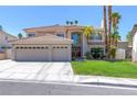 Spacious two-story home showcasing a three-car garage, mature landscaping and a tile roof at 3633 Fox Heather Dr, Las Vegas, NV 89129