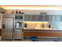 Modern kitchen with stainless steel appliances, wood cabinets and backsplash lighting at 3722 S Las Vegas Blvd # 1111, Las Vegas, NV 89113