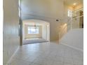 Bright living room featuring soaring ceilings, tile flooring, and a staircase at 3766 Port Ritchey St, Las Vegas, NV 89147