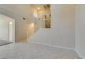 Bright living room featuring soaring ceilings, tile flooring, and a staircase at 3766 Port Ritchey St, Las Vegas, NV 89147
