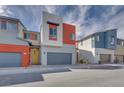 Charming two-story home with modern design, grey garage door, and red accent wall at 4349 Tabor Peak Ave, Las Vegas, NV 89141