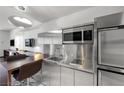 Bright modern kitchen featuring stainless steel appliances, island seating, and sleek fixtures at 4381 W Flamingo Rd # 3710, Las Vegas, NV 89103