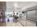 A modern kitchen featuring stainless steel appliances and sleek cabinets with hardwood flooring and a city view at 4381 W Flamingo Rd # 3710, Las Vegas, NV 89103