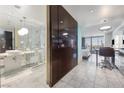 A modern open-concept condo featuring an island, kitchen, bath, and living space all brightly lit at 4381 W Flamingo Rd # 3710, Las Vegas, NV 89103