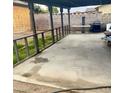 The covered back patio featuring a concrete floor, partially enclosed with a wooden railing at 4820 Mahogany Dr, Las Vegas, NV 89110