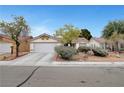 Charming single-story home with a well-maintained front yard and attached two car garage at 5220 Shasta Daisy St, North Las Vegas, NV 89031