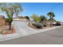 Street view of a charming single-story home with a well-maintained front yard at 5220 Shasta Daisy St, North Las Vegas, NV 89031
