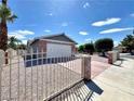 Charming single-story home featuring a gated entrance, red brick accents, and a two-car garage in a sunny neighborhood at 5460 Conville Pl, Las Vegas, NV 89120