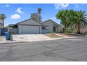 Well-maintained single-story home with an attached garage, neat landscaping, and inviting curb appeal at 6181 Cedarwood Ave, Las Vegas, NV 89103