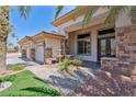 Lovely home showcasing a three car garage, stone accents, and a charming front entrance at 6224 Red Pine Ct, Las Vegas, NV 89130