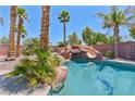 Inviting backyard pool with rock waterfall and water slide at 6224 Red Pine Ct, Las Vegas, NV 89130