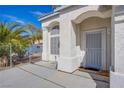 Home's inviting entryway features a secure screen door, arched window, and a landscaped garden view at 6259 Santander Ave, Las Vegas, NV 89103