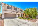 A two-story home with a two-car garage, a tile roof, and a manicured front yard at 6559 Musette Ave, Las Vegas, NV 89139