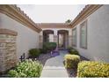 The entryway showcases a beautifully landscaped walkway and arched entrance leading to the front door at 66 Sunset Bay St, Las Vegas, NV 89148