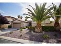 Beautiful single-story home featuring desert landscaping, palm trees, and a well-maintained yard at 66 Sunset Bay St, Las Vegas, NV 89148