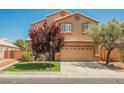 Charming two-story home with manicured lawn, desert landscaping, and a two car garage at 7690 Morning Lake Dr, Las Vegas, NV 89131