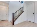 Bright entryway with a staircase featuring dark wood trim and white walls at 9756 Rock Cliff St, Las Vegas, NV 89141