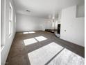 The spacious and bright living room features plush carpeting and ample natural light at 983 Plantain Lily Ave, Las Vegas, NV 89183
