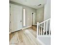 Bright entryway featuring hardwood floors, stylish wall trim and a view of the staircase at 10280 Midnight Meteor Ave, Las Vegas, NV 89166
