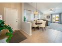 Open concept dining area featuring a round table, chandelier, and seamless access to the living room at 10336 Birch Bluff Ln, Las Vegas, NV 89145