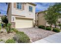 Charming home featuring a two-car garage, paved driveway, and well-maintained landscaping at 10512 Mann St, Las Vegas, NV 89141