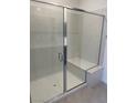 Modern bathroom shower with frameless glass doors and a built-in bench at 11407 Ethereal Landing Ave, Las Vegas, NV 89138