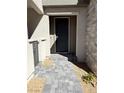 Inviting entryway with a gray paver pathway leading to a solid gray front door and stone veneer accents at 11423 Ethereal Landing Ave, Las Vegas, NV 89138