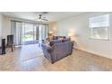 Inviting living room featuring neutral tones and sliding door access to the backyard at 12536 Blissful Sky St, Las Vegas, NV 89138