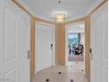 Bright foyer boasts neutral tones with a tile floor and leads to a living area with a view at 135 E Harmon Ave # 1102, Las Vegas, NV 89109