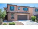 Charming home featuring a well-manicured lawn, two-car garage, and tasteful exterior details at 1405 Gilbert Creek Ave, North Las Vegas, NV 89031