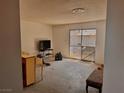 View of the empty living room with sliding glass doors to the backyard at 212 Hinkle St, Las Vegas, NV 89107