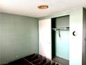 Empty room with built-in closet space, bare walls, and flooring at 212 Hinkle St, Las Vegas, NV 89107