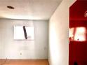Picture of an empty room with a window, bare walls, and flooring at 212 Hinkle St, Las Vegas, NV 89107