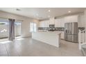 Modern kitchen featuring stainless appliances, a large island, and access to the backyard at 219 Cordelia Cove Ave # 513, Henderson, NV 89011