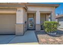Inviting front entrance featuring stone pillars, desert landscaping and a glass storm door at 2341 Steinke Ln, Las Vegas, NV 89108