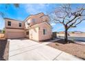 Charming two-story home with a tile roof and a wide driveway, perfect for families at 2407 Belt Buckley Dr, Henderson, NV 89002