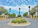 Elegant community entrance with palm trees, lush landscaping, and a security gate for added privacy at 2451 Tour Edition Dr, Henderson, NV 89074