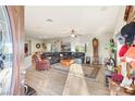 Spacious living room with hardwood floors, a ceiling fan, and a large leather sectional at 2720 Mickey Mantle Ct, Las Vegas, NV 89108