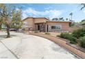 Charming exterior view of a two-story home with a well-manicured front yard and curved driveway at 2809 Mason Ave, Las Vegas, NV 89102