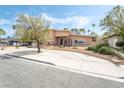 Front exterior showcases a two-story home with a circular driveway and mature trees at 2809 Mason Ave, Las Vegas, NV 89102