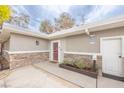 The house boasts a charming front entrance with a red door, stone accents, and a well-manicured planter at 2819 Taylor Ave, North Las Vegas, NV 89030