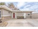 The house features a red door, stone accents, a tidy yard, and a concrete driveway leading to the entrance at 2819 Taylor Ave, North Las Vegas, NV 89030